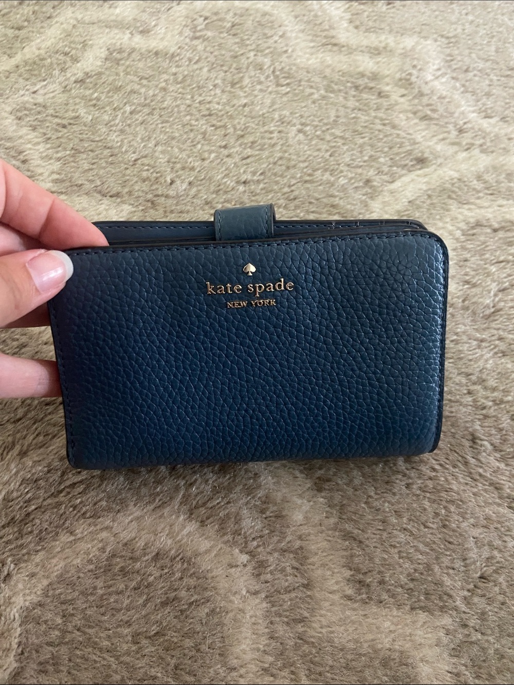 kate spade pebbled leather wallet in navy with gold logo